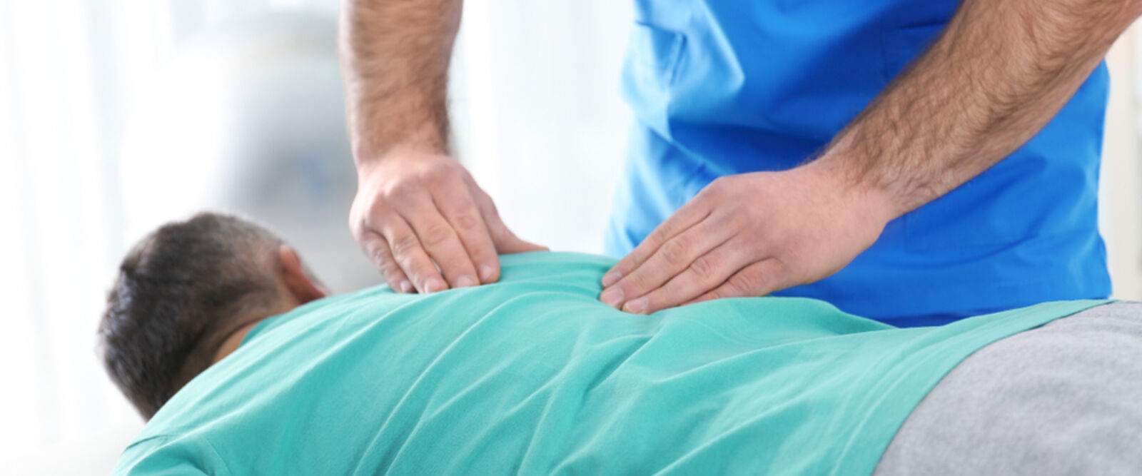 person laying down receiving chiropractic adjustment