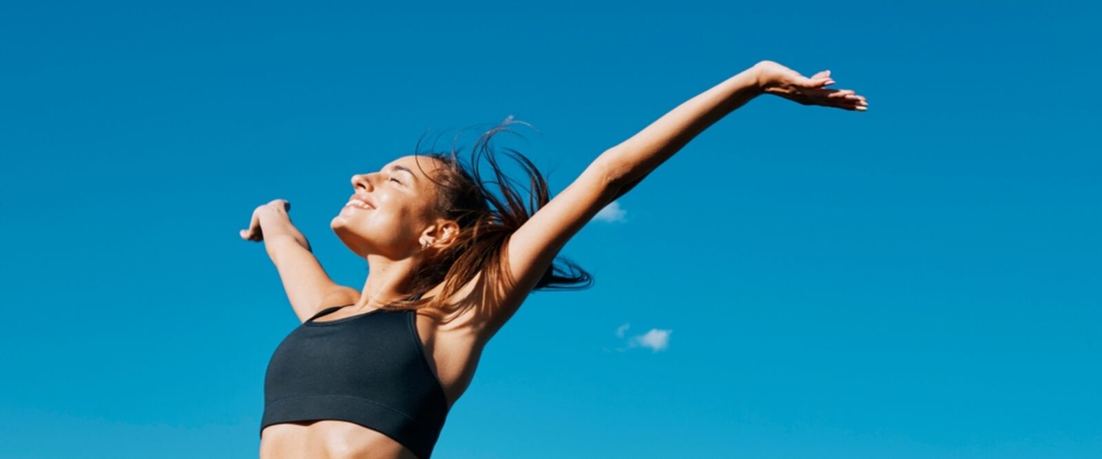 happy woman with arms extended up